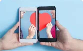 Two hands holding phones that together form a red heart